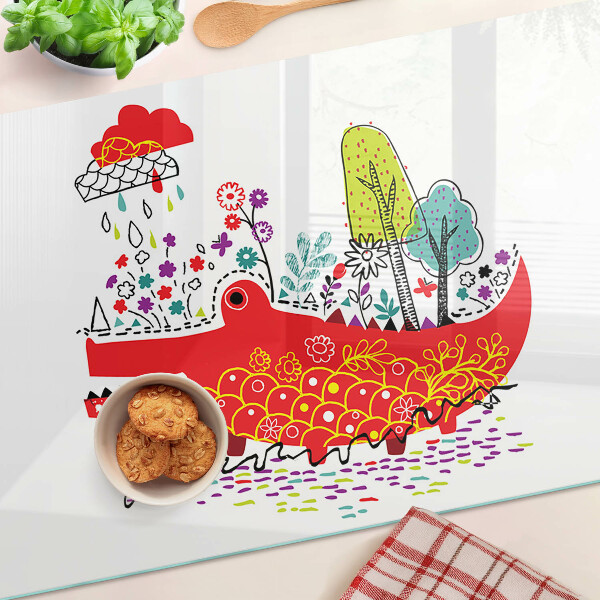Tocător din sticlă Crocodil într-un decor colorat