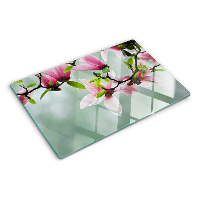 Tocător sticlă Flori de magnolie pe un fundal verde