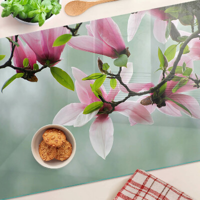 Tocător sticlă Flori de magnolie pe un fundal verde