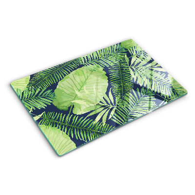 Tocător din sticlă Frunze tropicale pe un fundal întunecat