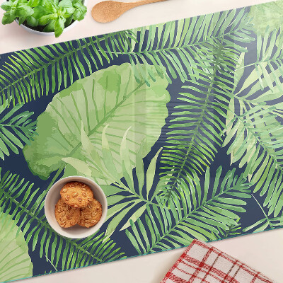 Tocător din sticlă Frunze tropicale pe un fundal întunecat