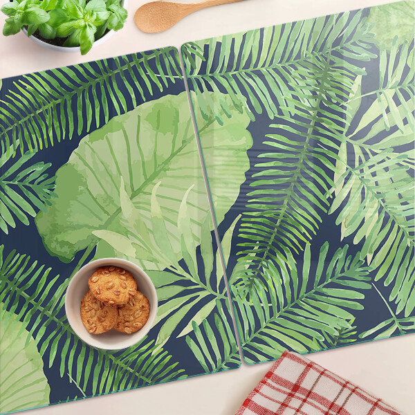 Tocător din sticlă Frunze tropicale pe un fundal întunecat