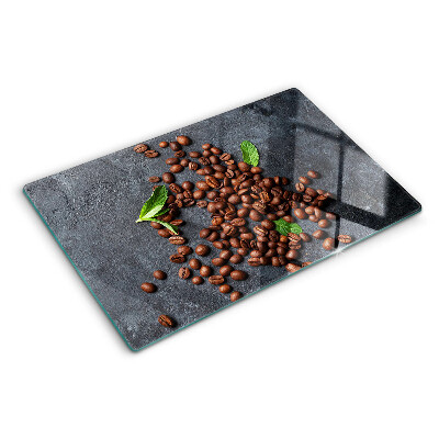 Tocător din sticlă Boabe de cafea pe un fundal de piatră