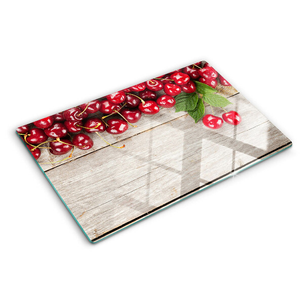 Tocător din sticlă Cireșe pe un fundal de lemn