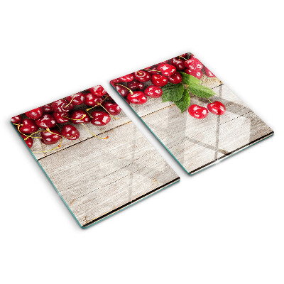 Tocător din sticlă Cireșe pe un fundal de lemn