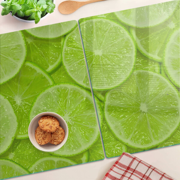 Tocător sticlă Felii de lime pe fundal verde