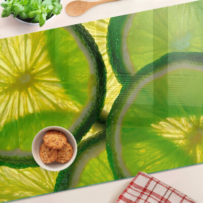 Tocător sticlă Felii de lime pe fundal verde