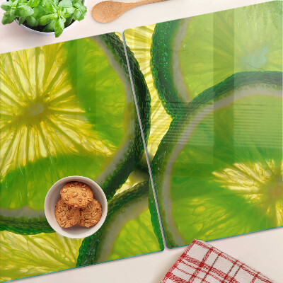 Tocător sticlă Felii de lime pe fundal verde