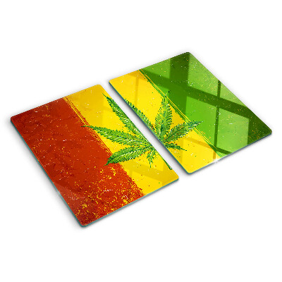 Tocător din sticlă Frunză de canabis pe un fundal colorat