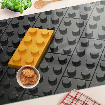 Tocător din sticlă Cărămizi LEGO pe fundal negru