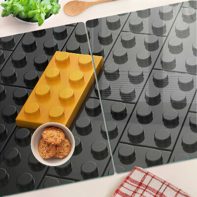 Tocător din sticlă Cărămizi LEGO pe fundal negru