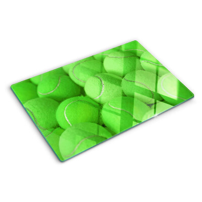 Tocător sticlă Mingi de tenis pe un fundal verde