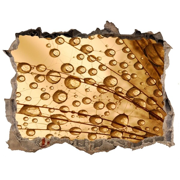 Autocolant gaură 3D O picătură aurie pe fundalul de beton