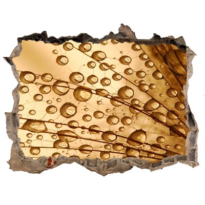 Autocolant gaură 3D O picătură aurie pe fundalul de beton